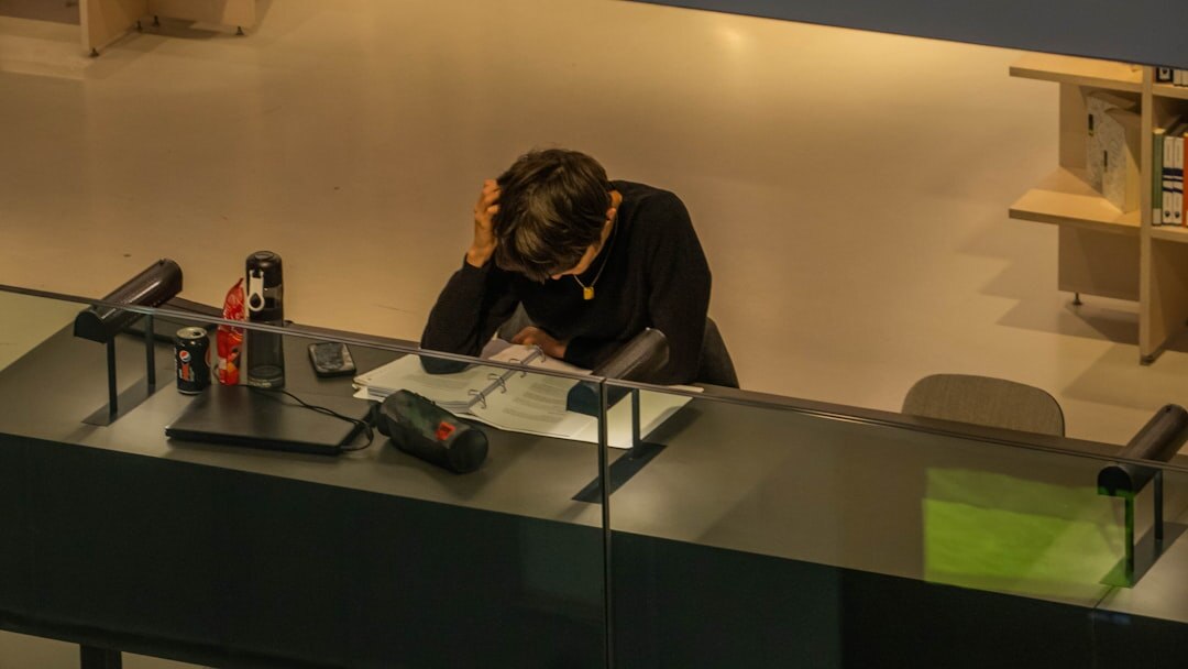 Dutch business owner in his fifties reviewing financial documents at a desk